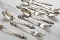 Closeup of vintage spoons and fork with decorative handles on the white table Royalty Free Stock Photo