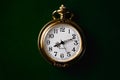 Closeup of a vintage worn-out gold pocket watch isolated on a black background Royalty Free Stock Photo