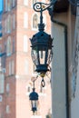 closeup vintage wrought iron lantern on the wall of a house