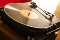 Closeup of vinyl on a player on the table under the sunlight with a blurry background Royalty Free Stock Photo