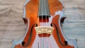 Closeup of violin bridge and strings on wooden background