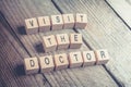 Closeup Of A Visit The Doctor Reminder Formed By Wooden Blocks On A Wooden Floo Royalty Free Stock Photo