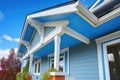 closeup of vivid blue overhanging eaves on white craftsman house