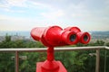 Closeup Vivid Red Binoculars on the Observation Deck with Copy Space