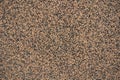 Closeup of wall with coarse brown and black pebbledash finish Royalty Free Stock Photo