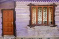 Closeup wall of an old wooden house with window and door. Royalty Free Stock Photo