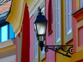 Closeup of wall sconce type retro style street lantern lamp. vintage concept. colorful stucco exterior wall background