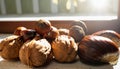 Closeup with walnuts and chestnuts on the windowsill where rays of sunlight shine through