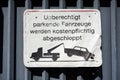 Closeup of a warning sign in German language illegally parked cars will be towed away Germany