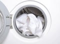 Closeup of washing machine drum and white clean towels Royalty Free Stock Photo