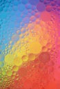 Closeup of water drops on glass with the reflection of rainbow colors Royalty Free Stock Photo