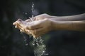 Closeup water flow to hand of women for nature concept on the garden background