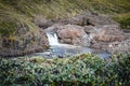 Closeup of a waterfall in a rocky environment on Island of kuannit, Disko Island in Greenland.