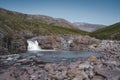 Closeup of a waterfall in a rocky environment on Island of kuannit, Disko Island in Greenland.