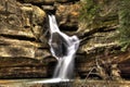 Closeup of a waterfall surrounded by rocks in the Hocking Hills State Park in Ohio, the US Royalty Free Stock Photo