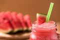 Closeup watermelon juice in glass on wood table with with slices