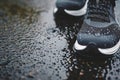 closeup of waterresistant sneakers on a wet pavement