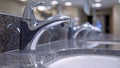 Closeup of a watersaving faucet with a motion sensor automatically turning off when not in use and reducing water