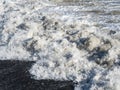 Closeup wave with foam on the beach of the Black Sea beach