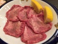 Closeup of waw beef tongue served with fresh lemon Royalty Free Stock Photo