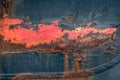 Closeup of a weathered ship hull with rust and red lead