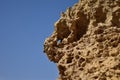 Closeup of the weathering of the globigerina limestone under the sunlight and a blue sky in malta