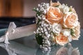 Closeup of a wedding bouquet next to wedding rings on glass Royalty Free Stock Photo