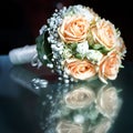 Closeup of a wedding bouquet next to wedding rings on glass Royalty Free Stock Photo