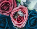 Closeup of wedding rings rose flowers Royalty Free Stock Photo