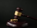 Closeup of wedding rings on wooden mallet at table in courtroom Royalty Free Stock Photo