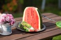 Closeup still life watermelon on brown wooden table with bokeh nature on background Royalty Free Stock Photo