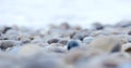 Closeup wet stones on the beach near waves on the sea