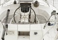 Closeup Of A Wheel And Deck Of A White Sailing Boat In Marina Royalty Free Stock Photo