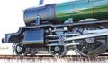 Closeup of wheels and con rods of renovated steam engine in England