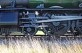 Closeup of wheels and con rods of renovated steam engine in England