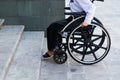 Closeup wheels of wheelchair with woman sitting in it, physical handicapped concept