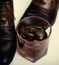 Closeup whiskey and men's shoes