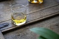 Closeup of a whisky glass on a shabby rustic wooden furniture Royalty Free Stock Photo