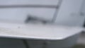 Closeup white airplane wing of personal small plane parked on airdrome. Royalty Free Stock Photo