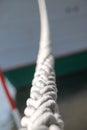 Closeup of a braided rope using as a mooring line for big ship. Photo with selective focus Royalty Free Stock Photo