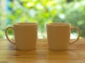 Closeup White Cofee Cup on the wooden table with White Brick wall background.