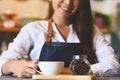 Closeup of white coffee cup with beautiful Asian woman barista background for serving to customer. Job and occupation. Food and Royalty Free Stock Photo