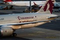 Closeup of a white commercial boing parked on a tarmac in Vienna