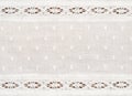 Closeup of white cotton fabric with lace borders