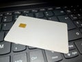 Closeup of white credit card with chip on black keyboard Royalty Free Stock Photo