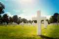 Closeup of a white cross military grave in the Normandy American Cemetery on a sunny day, Colleville-sur-Mer, France.