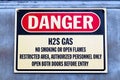 Closeup of a white Danger H2S Gas sign