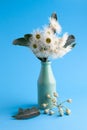 Closeup of white eucalyptus flowers in a vase.