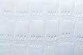 Closeup of white faux leather with crocodile embossing creating elegant texture Royalty Free Stock Photo