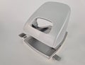 Closeup of white hole punch on gray background Royalty Free Stock Photo